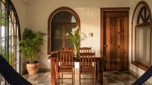a dining room with a wooden table and chairs at Villas Carrizalillo in Puerto Escondido