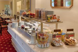 a buffet in a restaurant with food on a counter at Hotel Kronprinz Garni in Minden