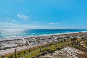 an aerial view of a beach with palm trees and the ocean at Portofino Tower 1-903 Beachfront Sunset Views in Pensacola Beach