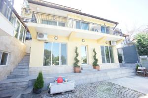 a house with a balcony on top of it at Kabakum Holiday Apartment in Varna City