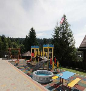 a playground with a slide and a swing set at VILLA PARAISO in Skhidnitsa