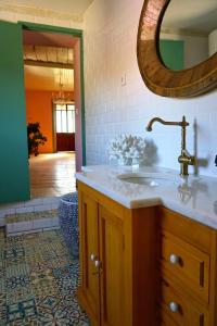 a bathroom with a sink and a mirror at São Miguel House , Casa do Carvalhal in Santarém