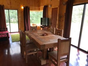 comedor con mesa de madera y sillas en Cabañas Trancura con Internet Satelital, en Pucón