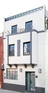 
a large white building with a large window at La Palomilla Bed & Breakfast in Mexico City
