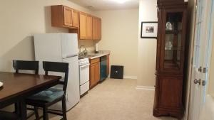 a kitchen with a table and a white refrigerator at SAFE NEIGHBORHOOD in Louisville