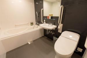 a bathroom with a white toilet and a sink at M's Hotel Kyoto Station Taruya in Kyoto