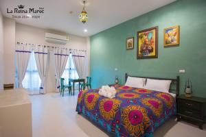 a bedroom with a bed with a colorful bedspread at La Reina Maroc Hotel ปากช่อง เขาใหญ่ in Pak Chong +88 photos
