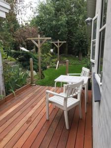 a wooden deck with a table and chairs on it at Bed and Breakfast Birkerod in Birkerød