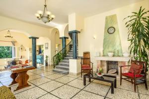 a living room with a staircase and a fireplace at Alinda Hotel in Alinda