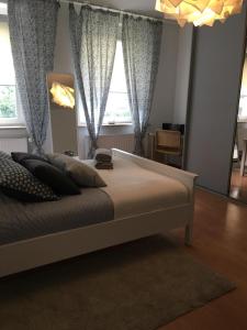 a bedroom with a large bed in front of a window at Sea Side Apartment in Gdańsk