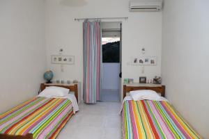 twee bedden in een kamer met een raam bij Euphoria - South Crete Villas in Achlia