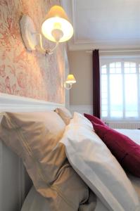 a bedroom with a bed with pillows on it at A L'Aube de Troyes in Sainte-Savine +10 photos