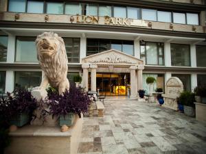 a lion statue in front of a building at Lion Park Suites & Residence Hotel in Aydın
