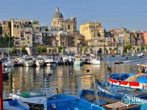 a group of boats docked in a harbor with buildings at FMR Oplonti PLINIO B&B in Torre Annunziata