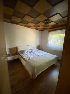 a bedroom with a bed in a room with a ceiling at Apartma Vražič in Bled