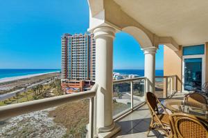 a balcony with chairs and a view of the ocean at Portofino Tower 1-903 Beachfront Sunset Views in Pensacola Beach