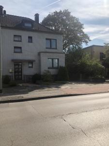 a house on the side of a street with a road at Wohnen auf Zeit in Duisburg