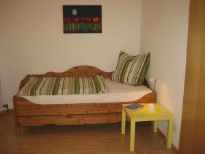 a bedroom with a wooden bed with a table at Appartement im Ahlesbrunnen in Bietigheim-Bissingen