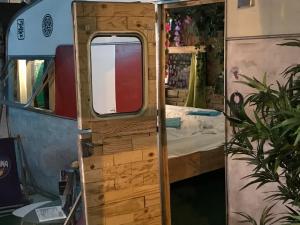 an open door to a bedroom in a rv at HafenTraum IndoorCampingHostel in Bremen