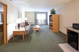 a living room with a couch and a tv at Holiday Inn Great Falls-Convention Center, an IHG Hotel in Great Falls