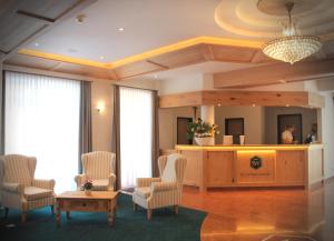 a hotel lobby with chairs and a reception desk at Hotel Schwabenwirt in Berchtesgaden