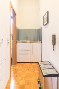 a kitchen with a sink and a bench in a room at Charming City Apartment with parking spot in Würzburg