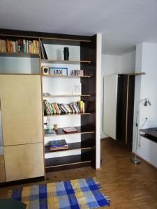 a room with a book shelf with books at Room in maisonette with garden, parking place in Vienna
