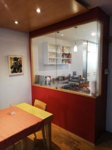 a kitchen with a counter and a table and a counter top at Room in maisonette with garden, parking place in Vienna