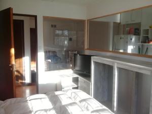 a bedroom with a bed and a tv in a room at Céntrico A-04 in General Roca +13 photos
