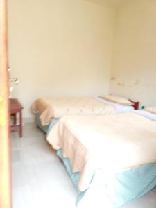 
A bed or beds in a room at Nkuringo Guest House
