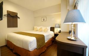 Postel nebo postele na pokoji v ubytování Le Tour Hotel Akihabara Ekimae 楽途ホテル秋葉原駅前店