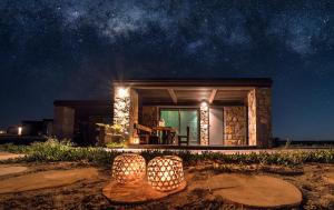 a small house with lights in front of it at night at Keros Blue - Luxury in Wilderness in Kalliópi