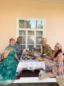 a group of people sitting around a table at Munis in Samarkand