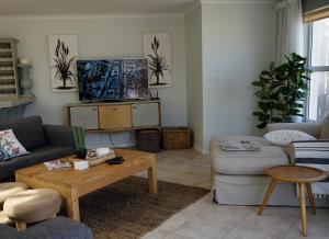 a living room with a couch and a coffee table at Beach Club 8 in Hout Bay