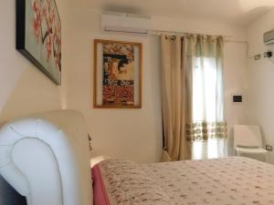 a bedroom with a bed and a window at Sos Manneddos in Posada