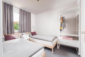 a bedroom with two beds and a window at NordseeHeide-Lodges Cuxhaven in Cuxhaven