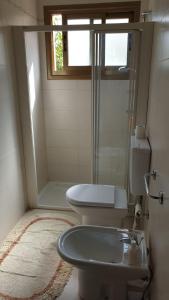 a bathroom with a shower and a toilet and a sink at Villa Bontempo in Gleris