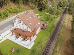 an overhead view of a large house with a train at Ameisenberg Appartement in Oybin