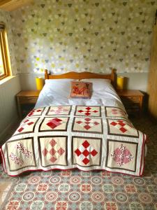 a bed with a quilt on it in a bedroom at PieNook in Blandford Forum