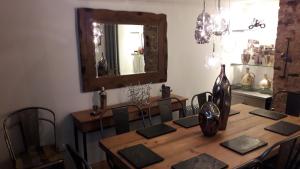 a dining room with a table with chairs and a mirror at Havisham House in Woburn