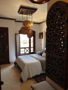 a bedroom with a bed and a large window at Dar Om Ali ElGouna Sabina y160 2 14 in El Gouna +27 photos