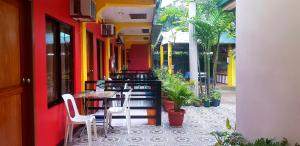 a restaurant with a table and chairs on a patio at Amelia Homestay in Puerto Princesa City