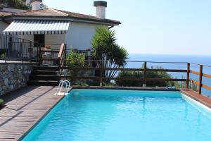 a swimming pool with a view of the ocean at villa panoramica in Lavagna