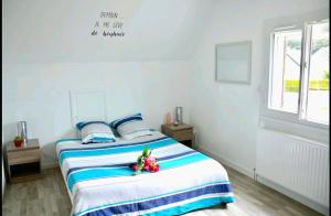 a bedroom with two beds and a window at À 10 minutes de voiture d'Étretat in Les Loges