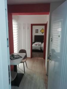 a room with a table and a bed in a bedroom at Apartman Centar 2 in Užice