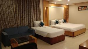 Ένα ή περισσότερα κρεβάτια σε δωμάτιο στο Hotel Tridev