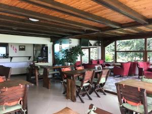 a restaurant with wooden tables and red chairs at Sapanca Dilek Konagi Hotel in Sapanca