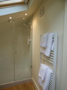 a bathroom with a shower and white towels at Hunters Moon B&B in North Tidworth