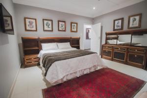 a bedroom with a bed and a mirror and a red rug at The Afropolitan in Johannesburg