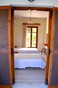 a bedroom with a bed and a window at Kostas' Garden in Roda